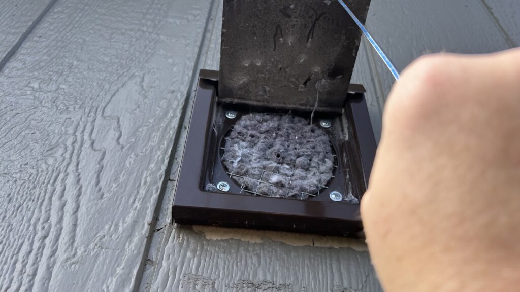 Dryer vent termination clogged with lint due to bird screen in Lubbock TX