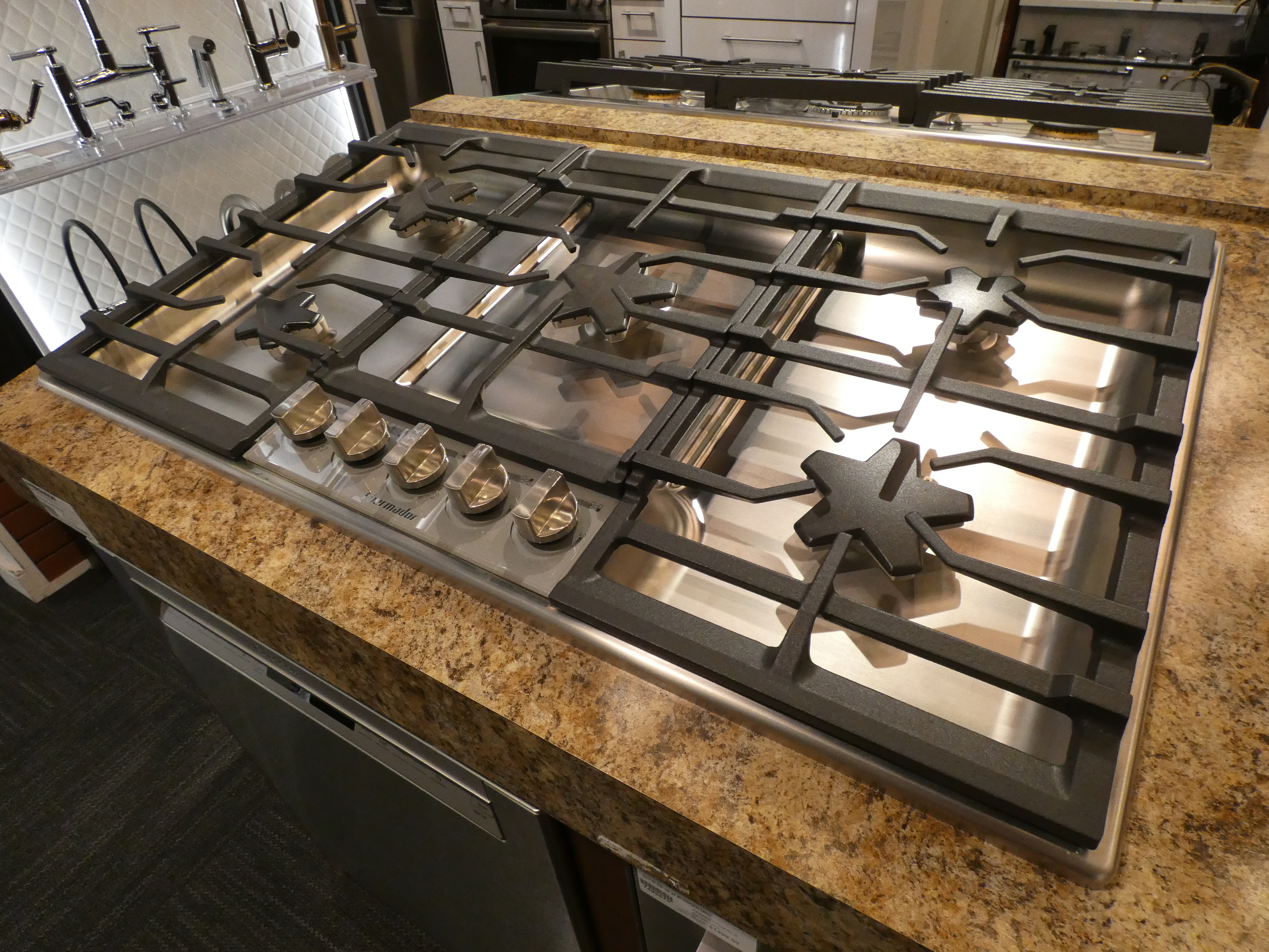 Gas cooktop installed in kitchen counter where model and serial number tag is found underneath