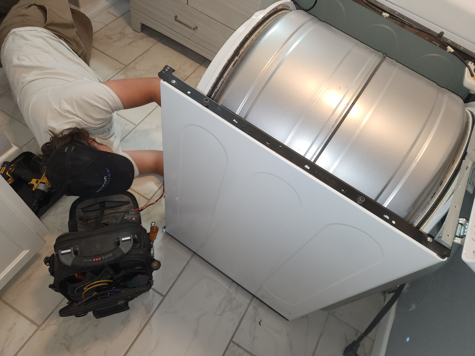Dryer repair in Lubbock - technician servicing an LG dryer drum