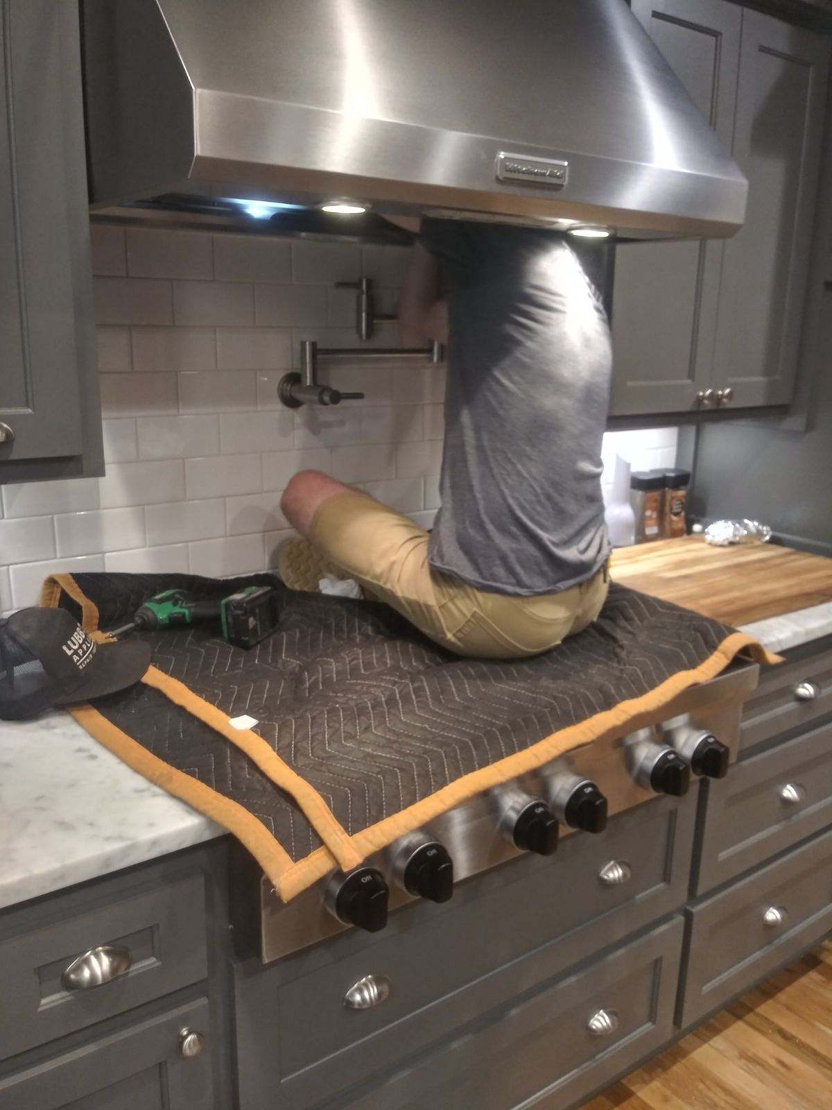 Technician repairing a range hood in Lubbock TX