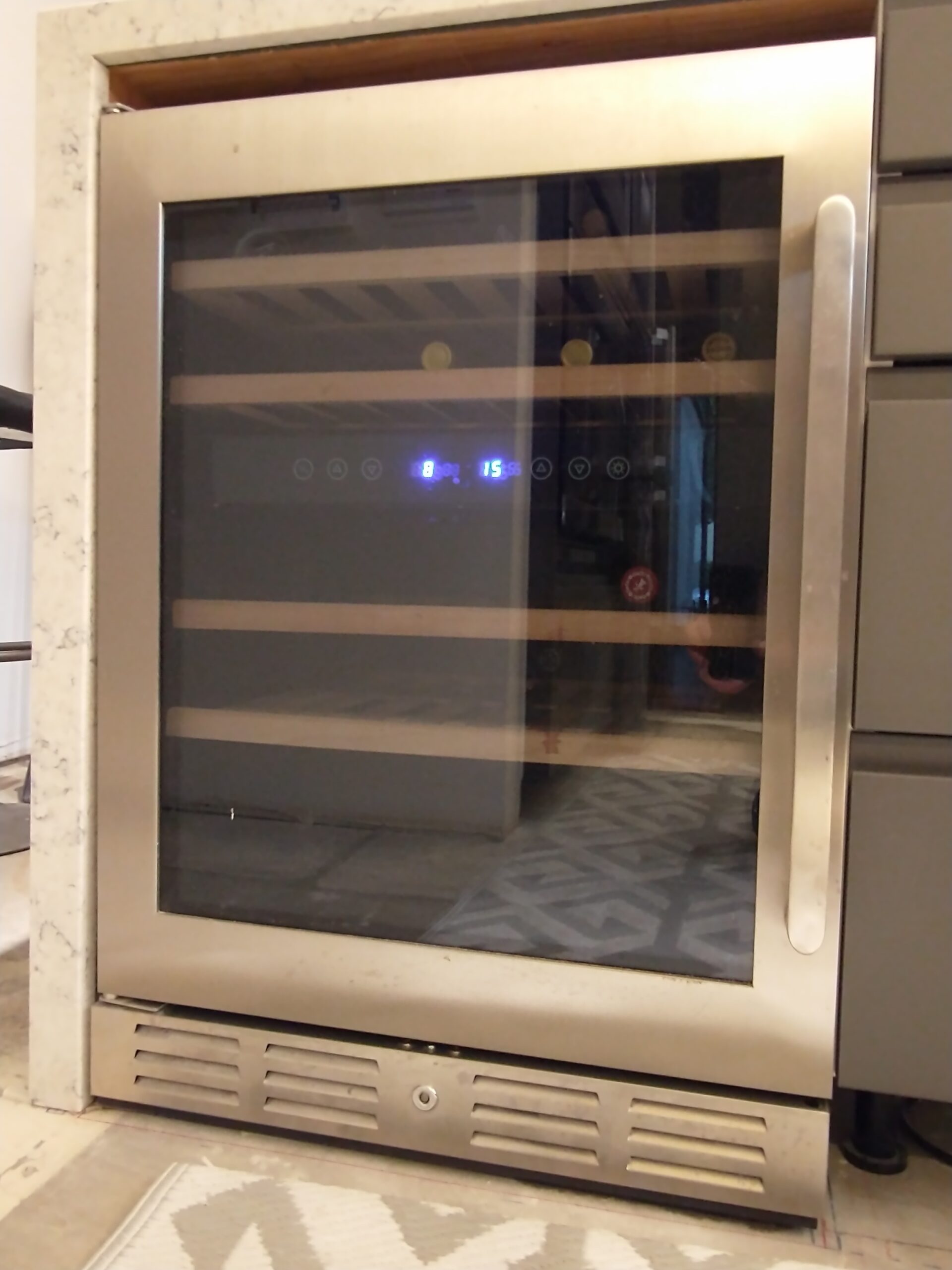 Wine cooler fridge in kitchen where model and serial number tag is typically on the back or inside wall